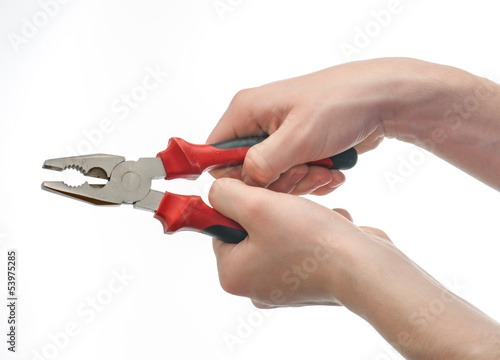 Caucasian young both hands gripping pliers isolated