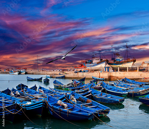 Blue fishing boats on an ocean coast in Essaouira, Morocco