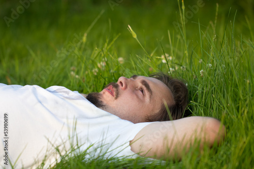 man relaxing on the grass