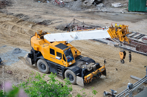 Mobile crane at the construction site. © badztua