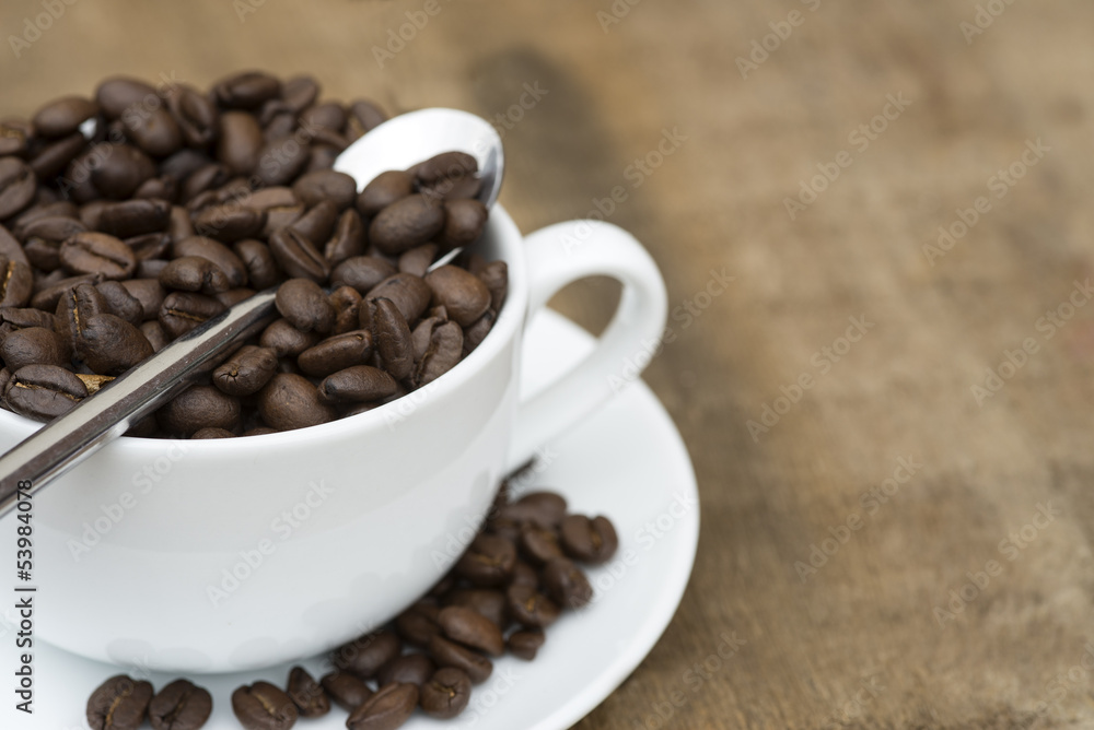 Cup of coffee and beans on wooden background Cup of coffee and beans on wooden background