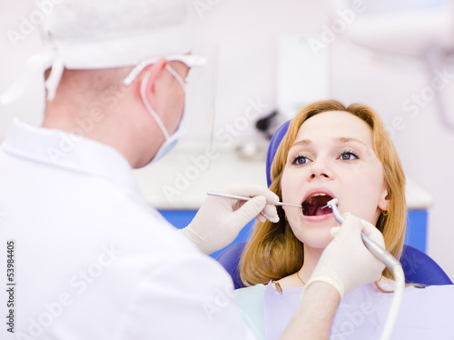 young woman with open mouth during drilling treatment 