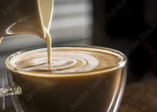 Pouring Creamer into Coffee
