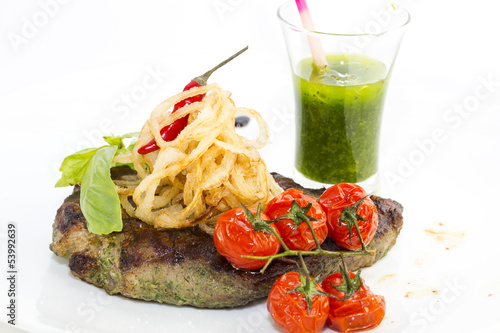 Grilled steak with sauce and greens on white background