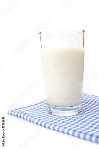 A Glass of milk on plaid towel, isolated on the white.