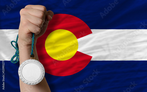 Silver medal for sport and  flag of american state of colorado photo