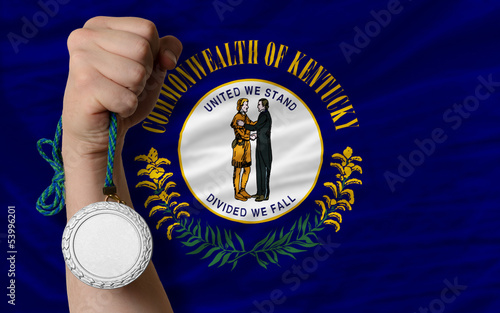 Silver medal for sport and  flag of american state of kentucky photo