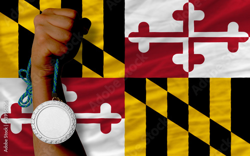 Silver medal for sport and  flag of american state of maryland photo