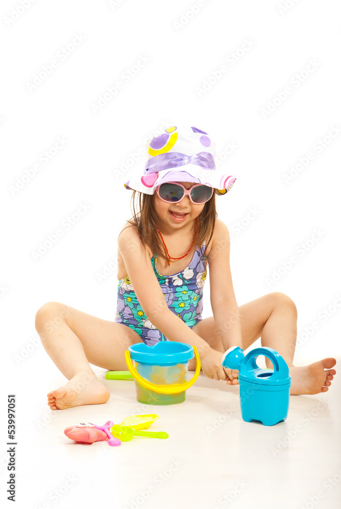 Cheerful girl playing with beach toys Cheerful girl playing with beach toys