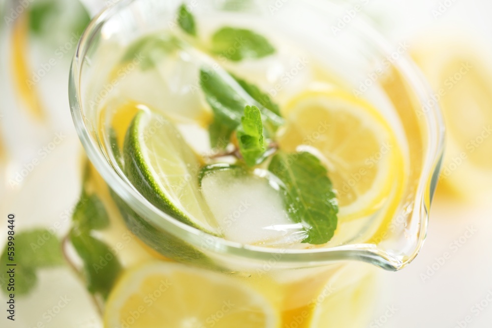 Detail of glass jug with fresh lemonade. Detail of glass jug with fresh lemonade.