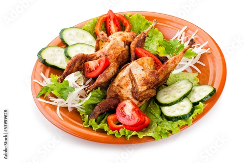 Two whole quail with cucumber, tomatoes and onion