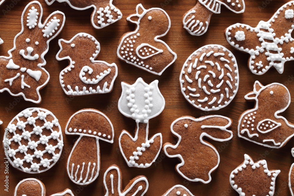 Easter gingerbread cookies on wooden background.