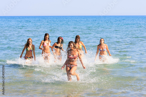 happy teenagers girls in the sea