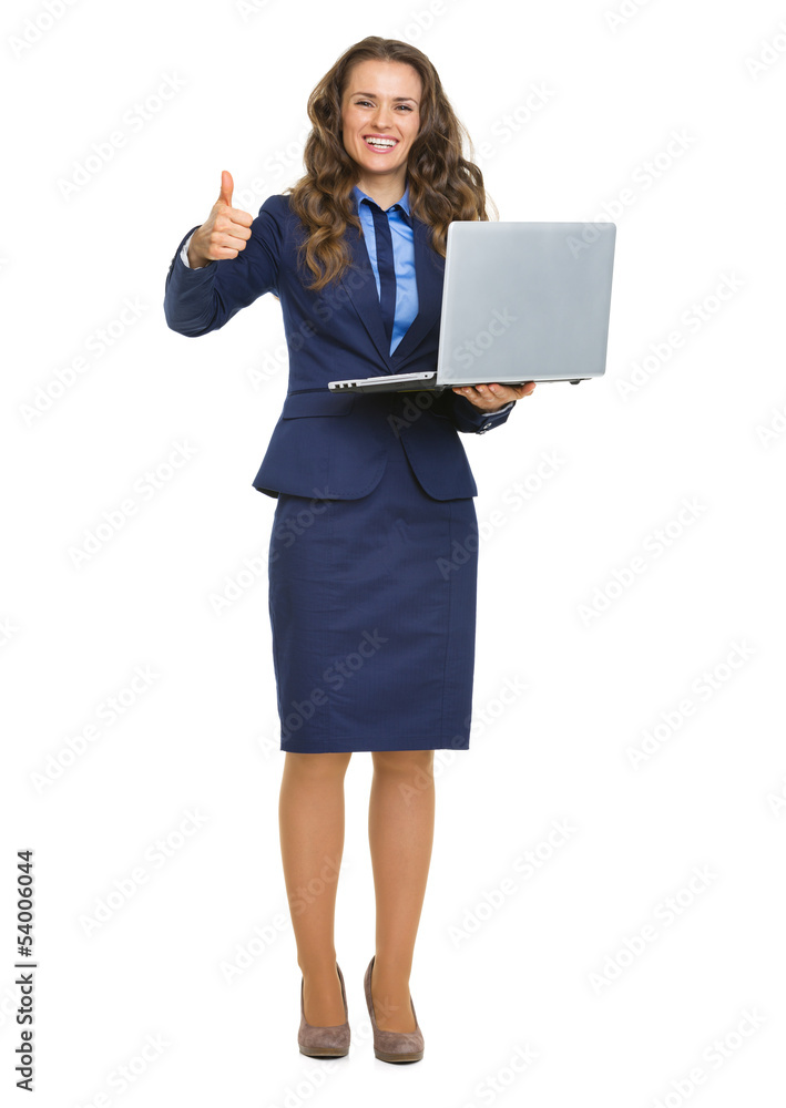 Smiling business woman with laptop showing humbs up Smiling business woman with laptop showing humbs up