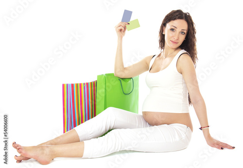 Pregnant woman holding credit cards and bags.