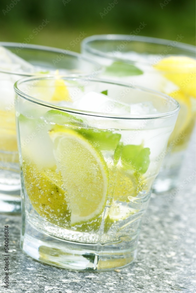 Fresh drink with ice cubes, lemon, lime and mint. Fresh drink with ice cubes, lemon, lime and mint.