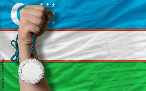 Silver medal for sport and  national flag of uzbekistan photo