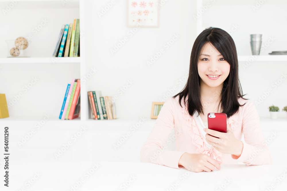attractive asian woman using smart phone in the room attractive asian woman using smart phone in the room