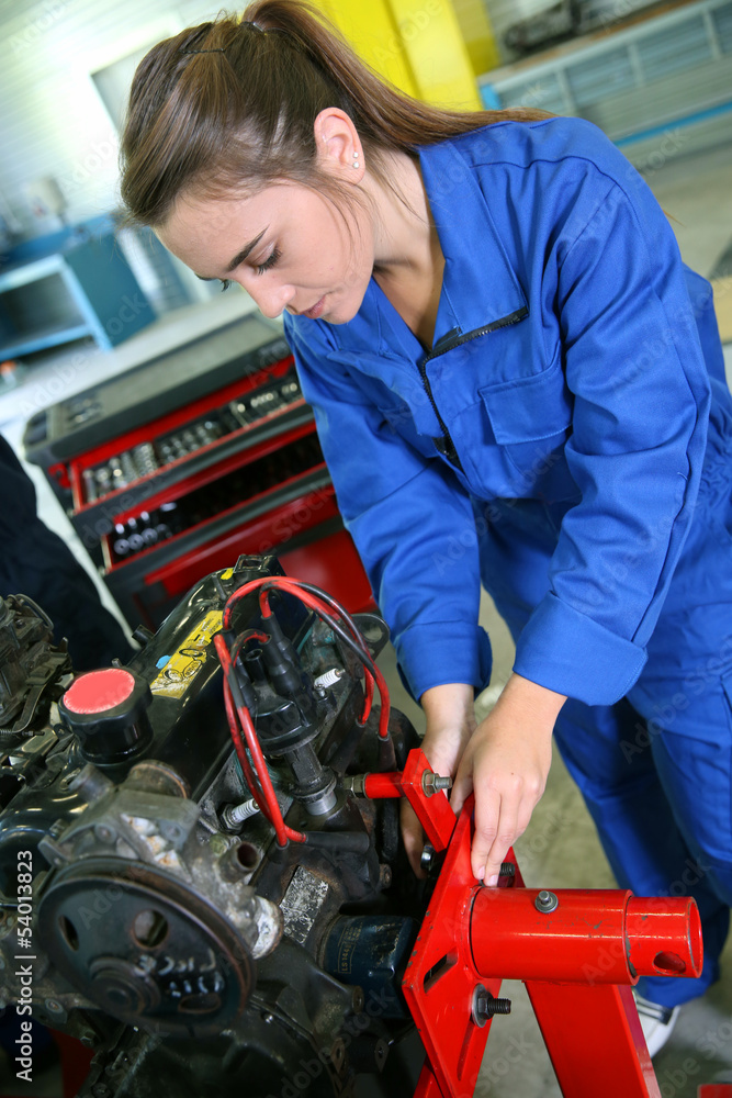 Fototapeta premium Student girl working in auto repairshop