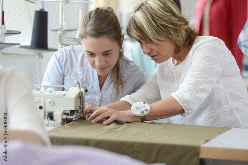 Student with teacher in dressmaking class photo