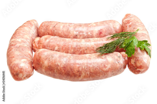 Raw meat sausages with greens isolated on white background