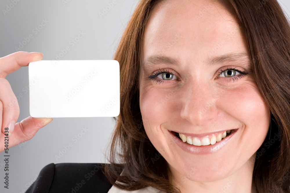 Beautiful woman holding business card on gray Beautiful woman holding business card on gray