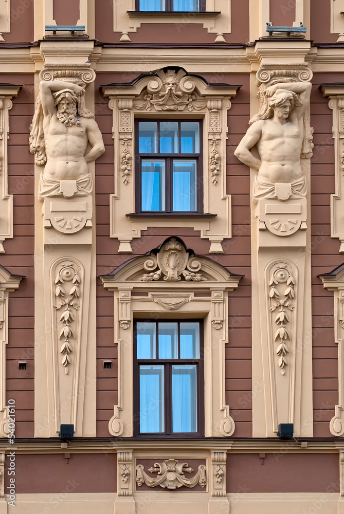 The facade of the building with antique sculptures.