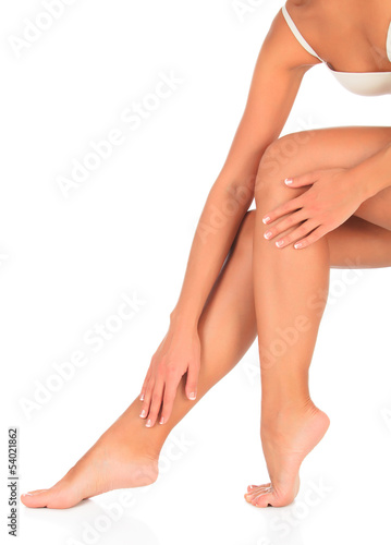 Woman touches her leg by hand