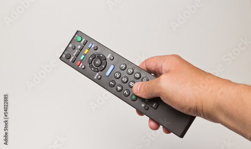 hand with the TV remote control