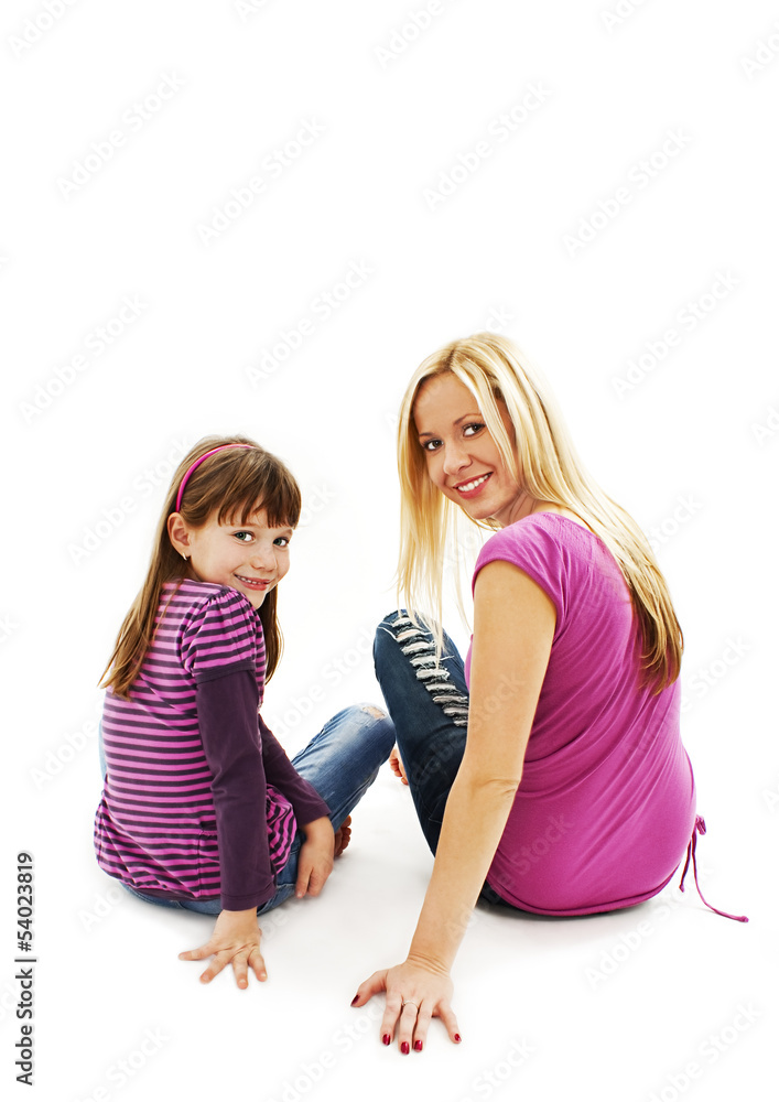 Beautiful mother and daughter sitting on the floor Beautiful mother and daughter sitting on the floor