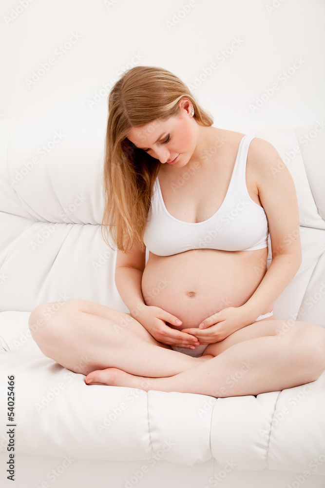 pregnant woman sitting in sofa pregnant woman sitting in sofa