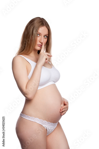 Pregnant woman finger to her lips