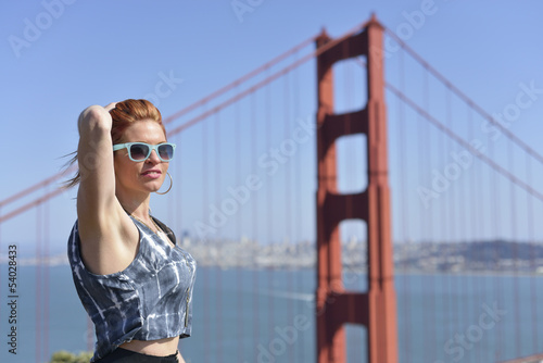 Woman in blue sunglasses posing by Golden Gate Bridge © Roijoy