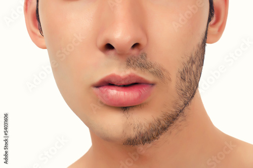 Portrait of a young beautiful man with half face shaved