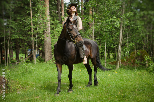 Cowgirl on brown horse