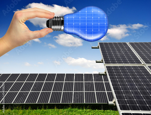 solar panels with hand holding  bulb