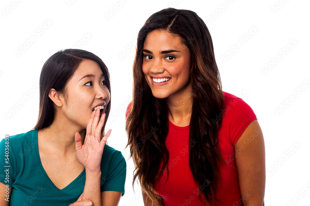 Two pretty young girls gossiping Two pretty young girls gossiping