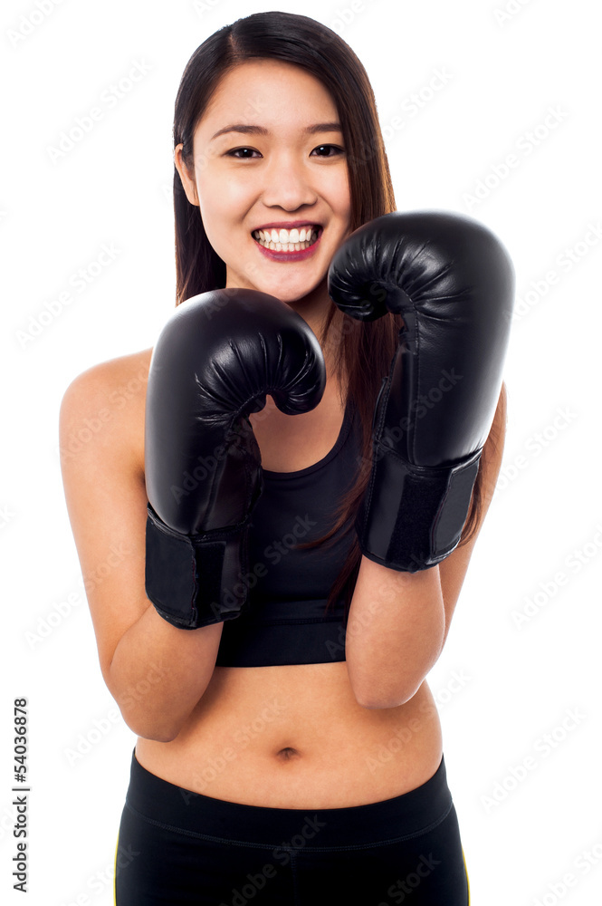 Girl wearing lightweight boxing gloves