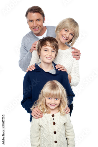 Family of four posing in a row © stockyimages