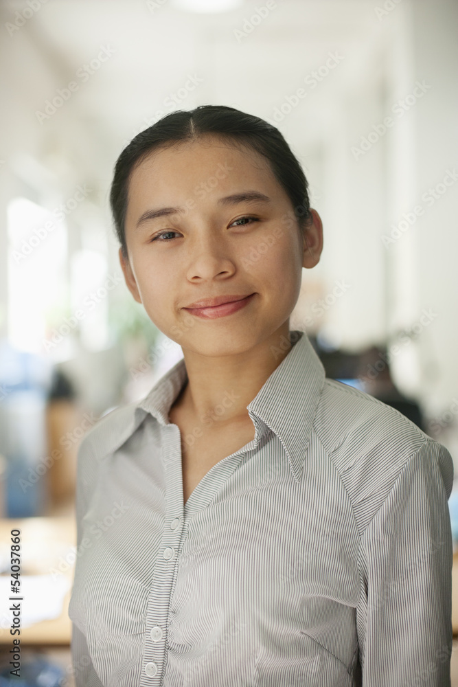 Young woman smiling in the office, portrait Young woman smiling in the office, portrait
