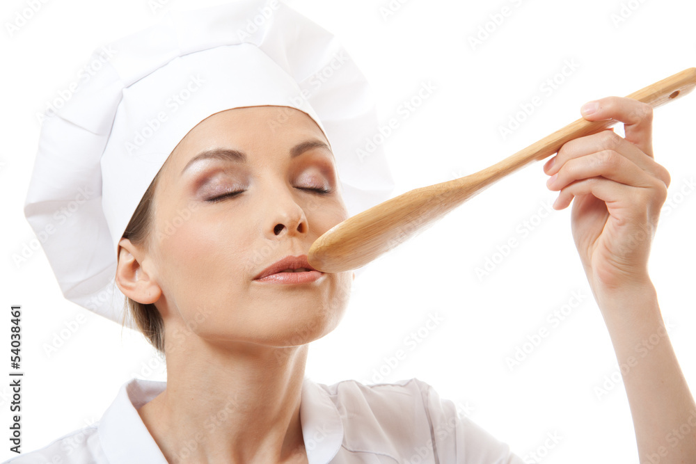 Woman cook eating with spoon, isolated on white background Woman cook eating with spoon, isolated on white background