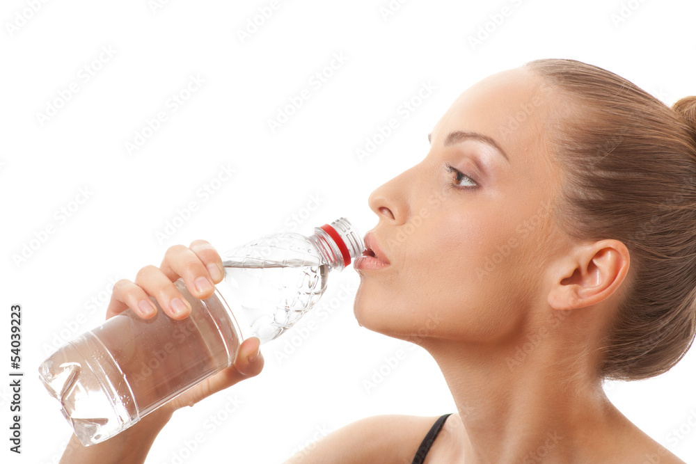 Woman in fitness wear drinking water, isolated on white Woman in fitness wear drinking water, isolated on white