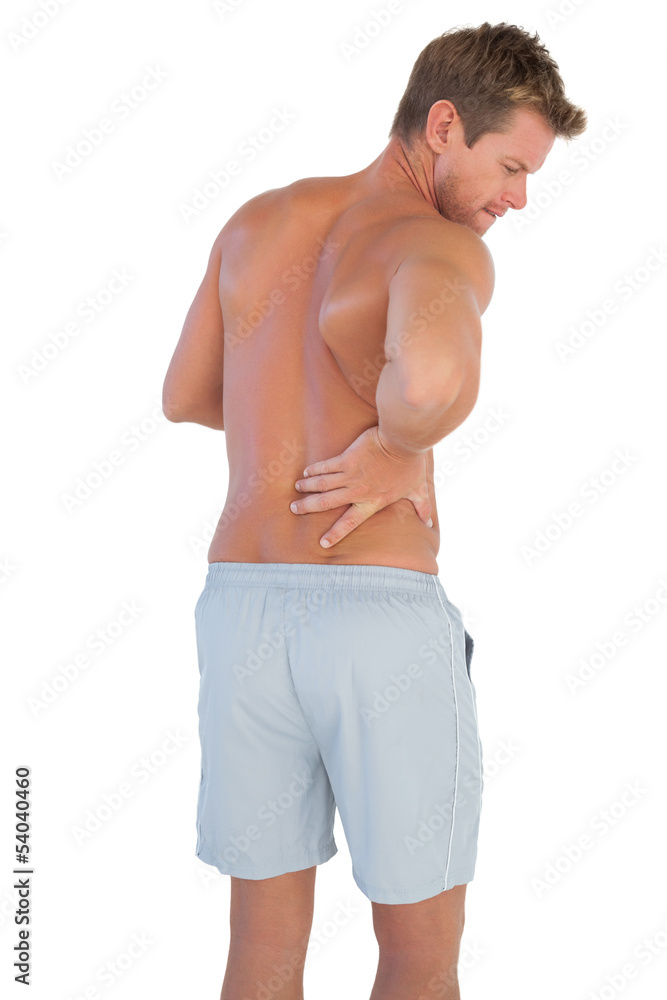 Handsome man with shorts suffering from back pain