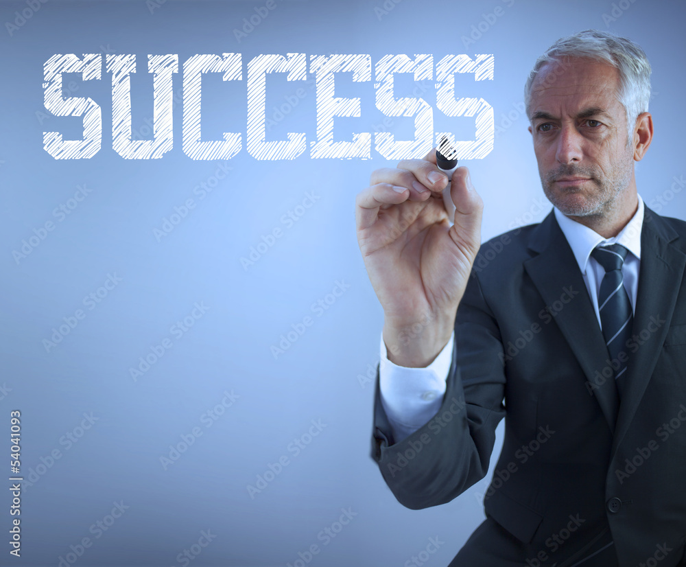 Businessman writing the words success Businessman writing the words success