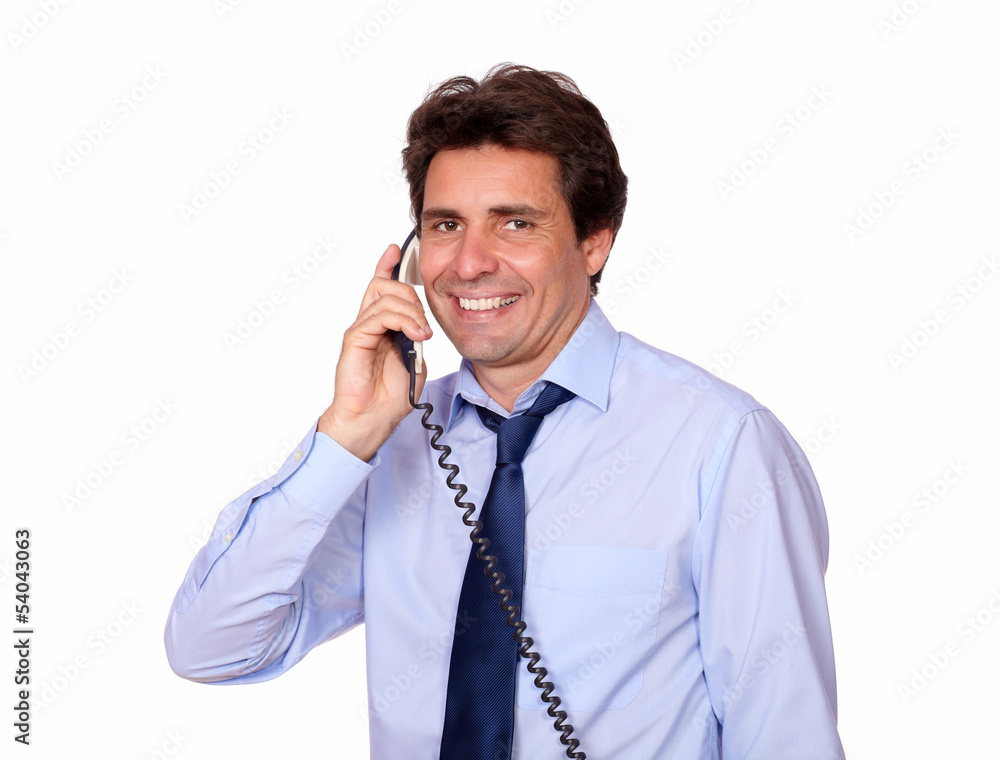 Smiling man looking at you and speaking on phone Smiling man looking at you and speaking on phone