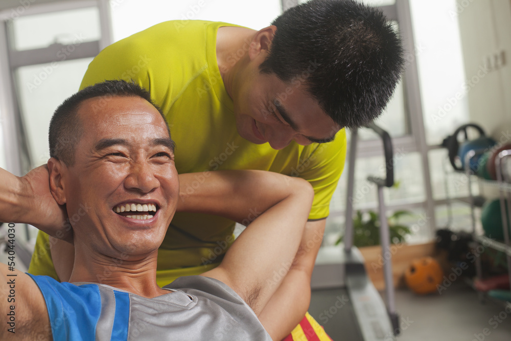 Man working out with his trainer Man working out with his trainer