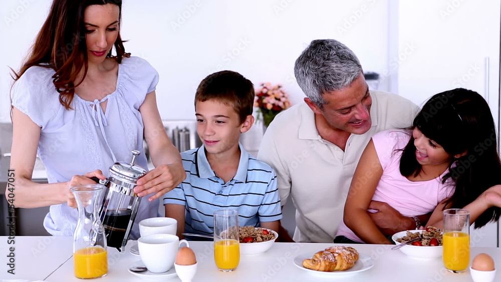 Description: Family having breakfast in the kitchen Description: Family having breakfast in the kitchen