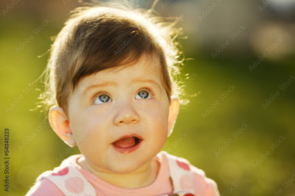 baby sitting on grass in garden baby sitting on grass in garden