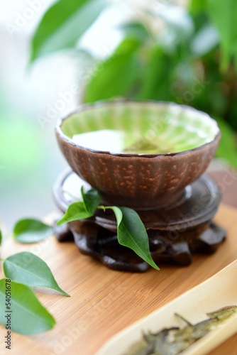 Healthy green tea cup with leaves