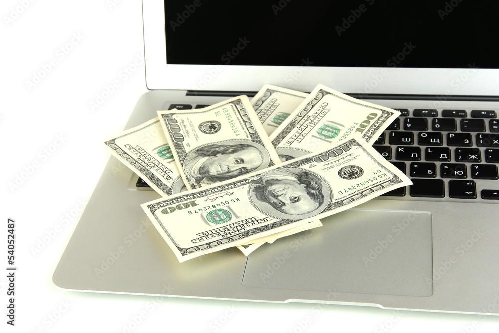 Money on laptop isolated on white Money on laptop isolated on white
